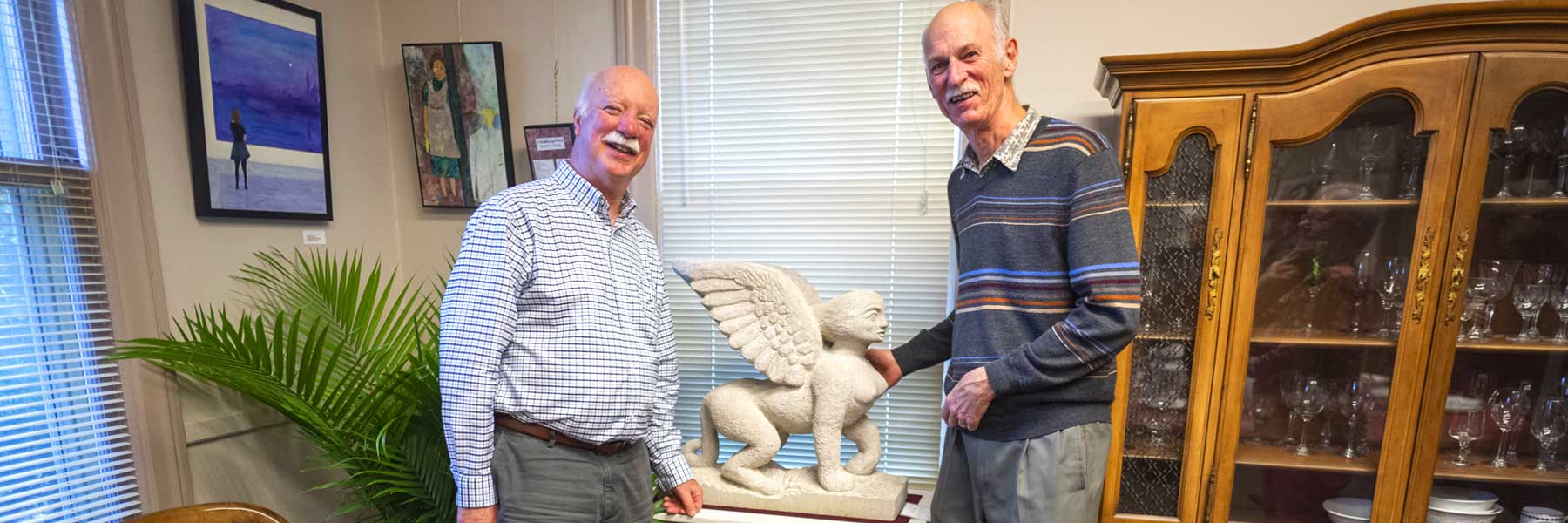 two people admiring a sculpture