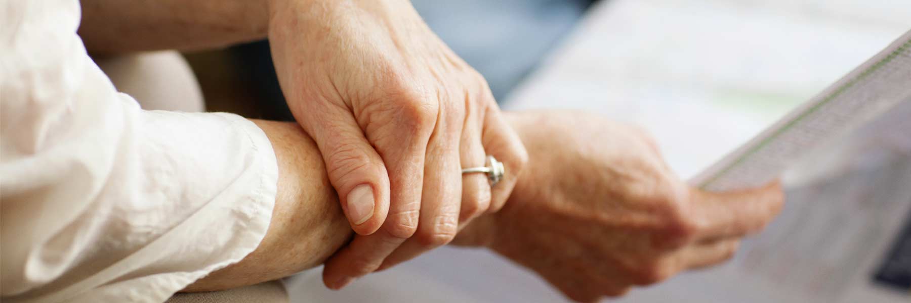 Close-up of hands holding papers 